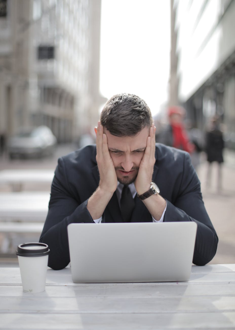 pensive man looking at computer laptop